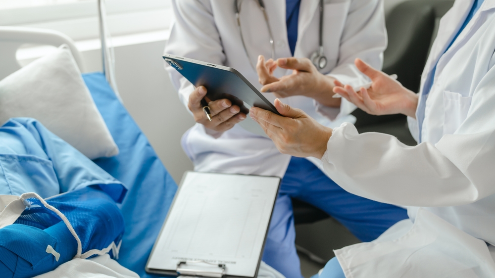 Close-up on a medical team speaking to patient with injured arm