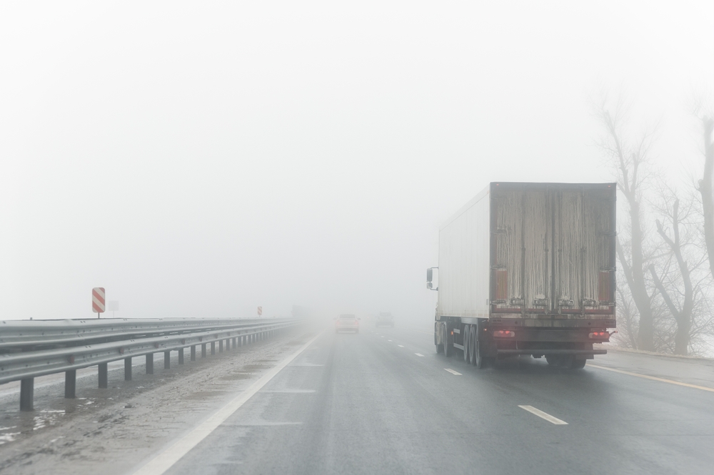 POV of driver behind semi truck in near whiteout conditions